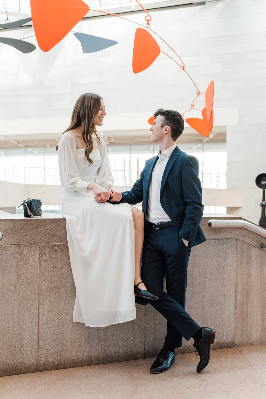 Engaged couple beneath the Calder mobile in the East Building atrium, National Gallery of Art, Washington DC by Kevin Socola Films