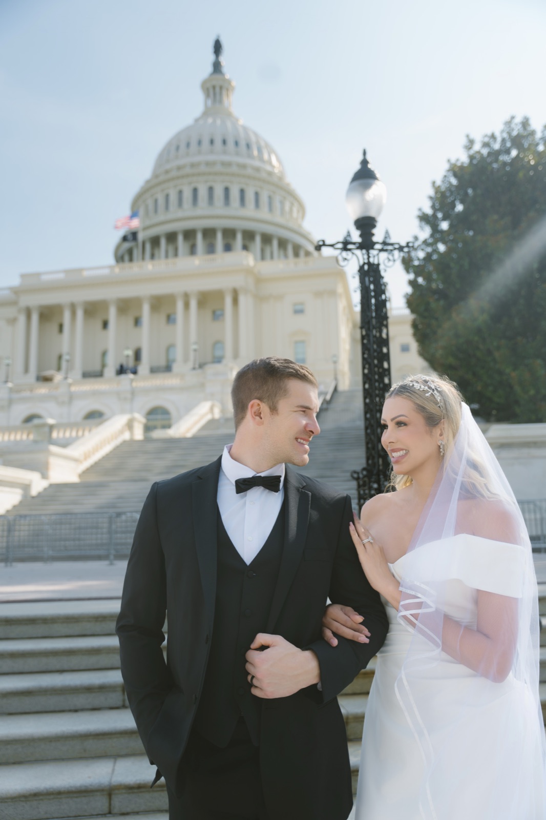 Couple arm in arm in front of the U.S. Capitol dome in Washington, DC by Kevin Socola Films