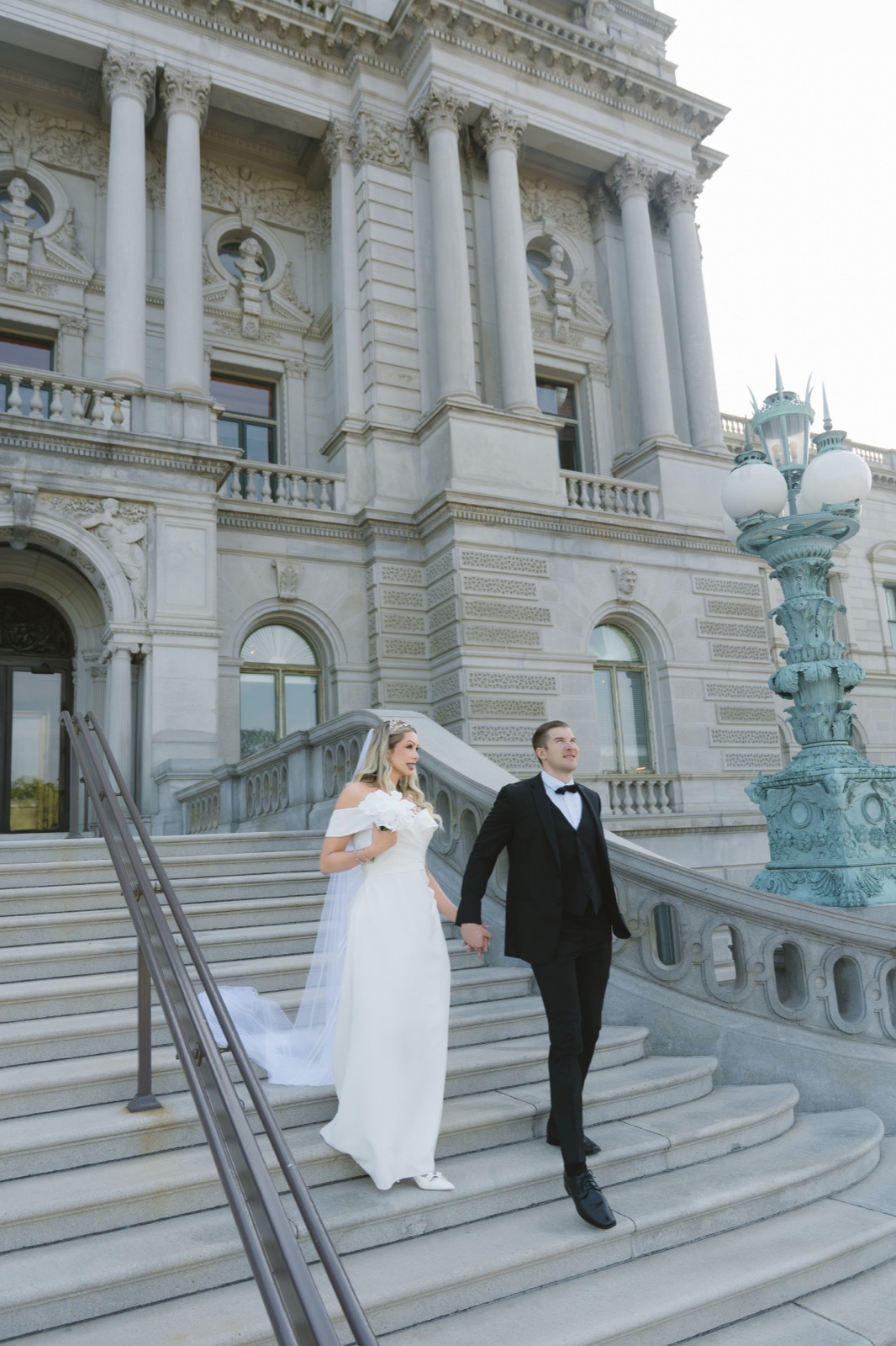 Bride and groom walking the grand staircase on Capitol Hill in Washington, DC by Kevin Socola Films