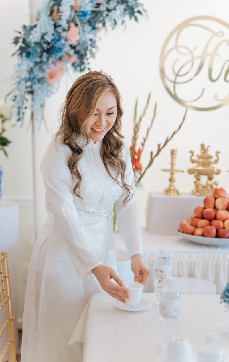 Vietnamese áo dài bridal portrait — bride in white silk áo dài with pearl details, soft natural light, photographed by Kevin Socola Films
